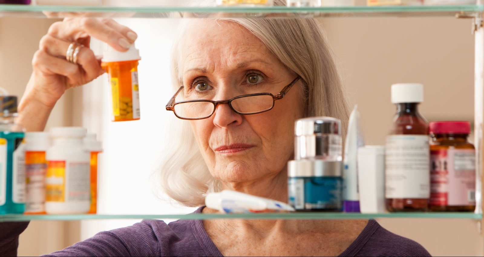 Senior woman reviewing prescription costs and Medicare plan bills